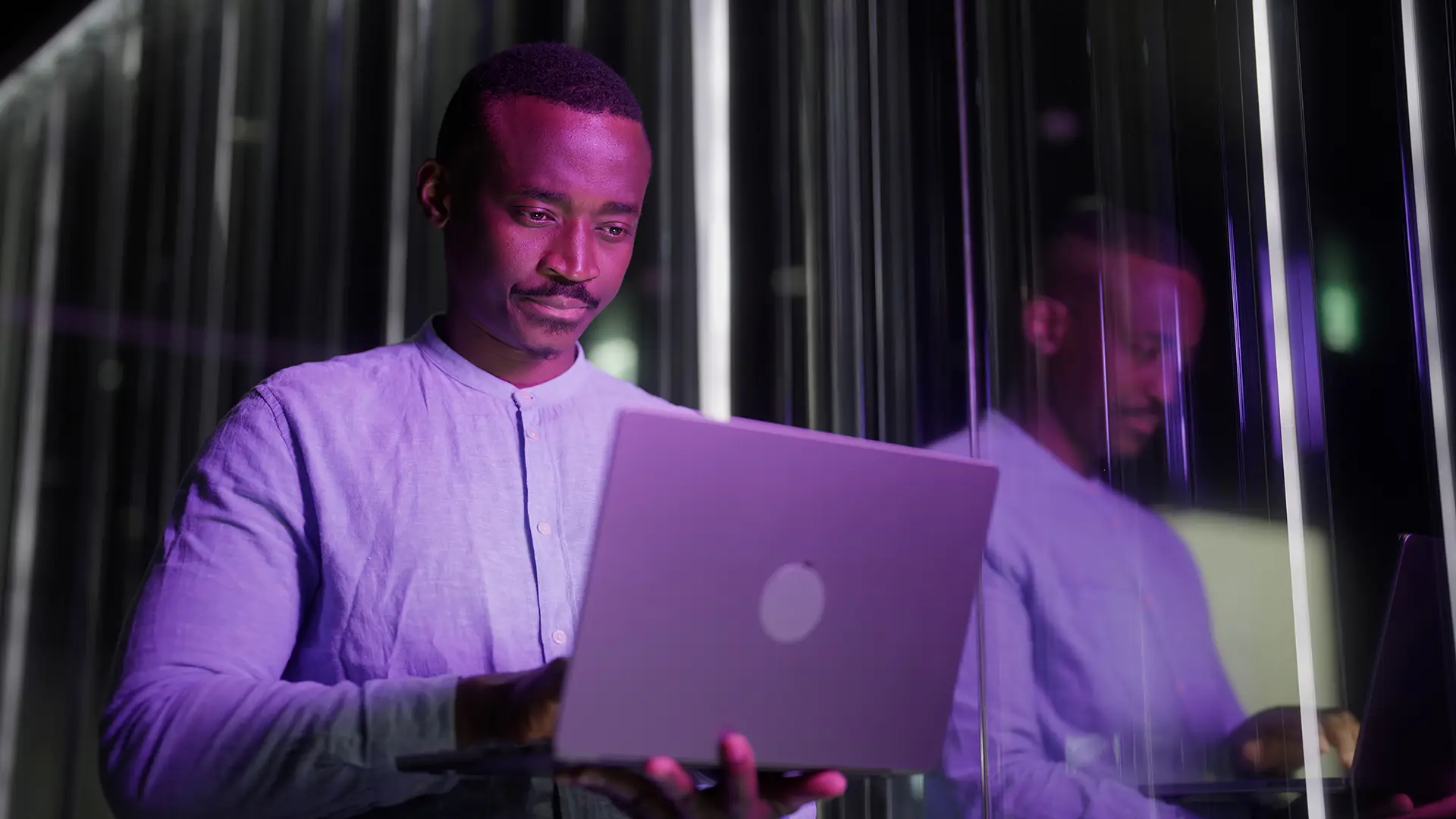 Black ethnic businessman using his laptop in modern office