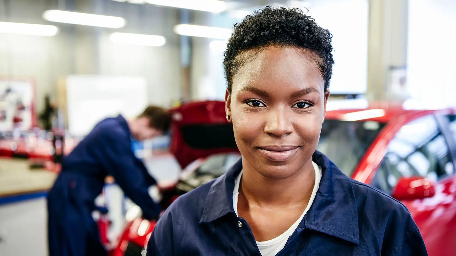 Female apprentice in her 20s smiling towards camera
